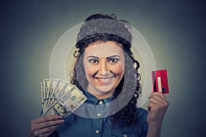 Woman showing credit card and cash dollar banknotes bills