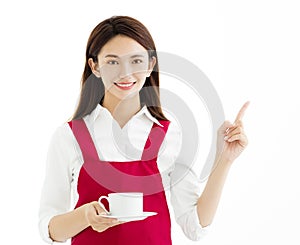 Woman showing cup of coffee and pointing gesture