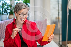 Woman showing decoration in smartphone screen