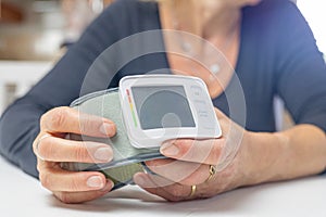 Woman is showing empty blood pressure monitor