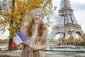 Woman showing flag on embankment near Eiffel tower, Paris