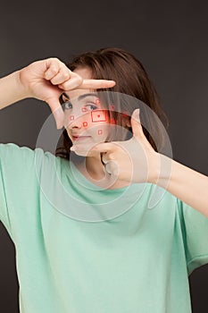 Woman showing frame with fingers