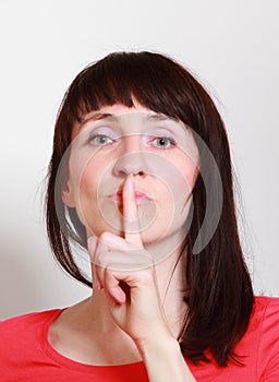 Woman showing hand silence sign