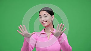 Woman Showing Heart Shape Sign On Green Background