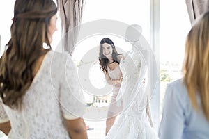 Woman Showing Her Chosen Wedding Dress To Friends