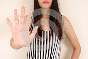 Woman showing her denial with NO on her hand.