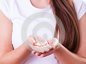 Woman showing her hands, holding something photo