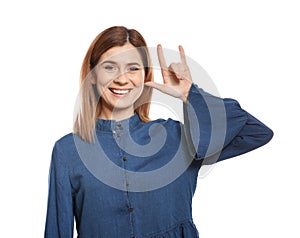 Woman showing I LOVE YOU gesture in sign language on white