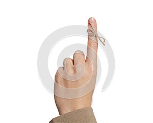 Woman showing index finger with tied bow as reminder on white background, closeup