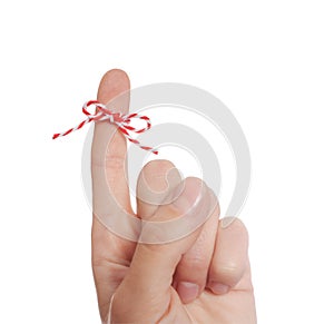 Woman showing index finger with tied bow as reminder on white background, closeup