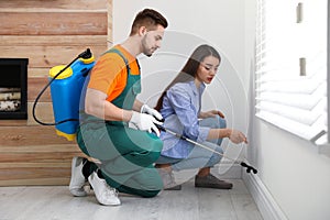 Woman showing insect traces to pest control worker