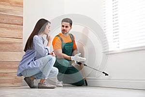 Woman showing insect traces to pest control worker