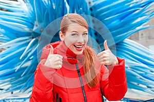 Woman showing like thumbs up gesture with both hands