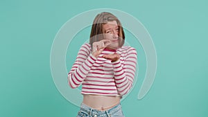 Woman showing a little bit gesture with sceptic smile showing minimum sign measuring small size