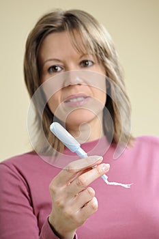 Woman showing menstrual applicator