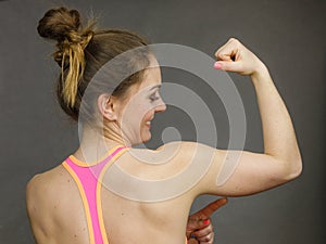 Woman showing muscles of the back and shoulders