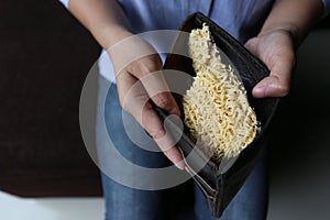 Woman showing noodles in pockets photo