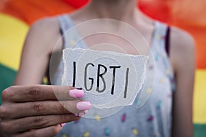 Woman showing a note with the text LGBTI