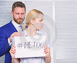 Woman showing a note with the text me too. Sexual harassment at work and workplace. Sexual assault and harassment at