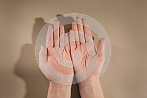 Woman showing palms on color background. Chiromancy and foretelling photo