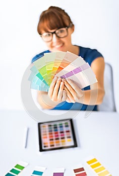 Woman showing pantone color samples