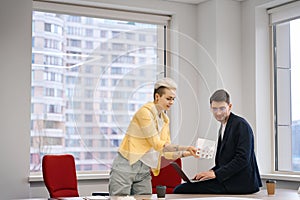 Woman showing paper layout of the house