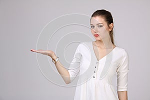 Woman showing a product. Empty copy space on the open hand palm.