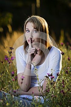 Woman showing quiet sign