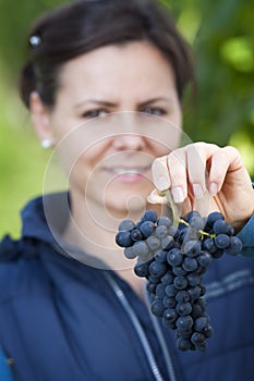 Woman showing red grape