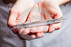 Woman is showing set of tools for professional cosmetology