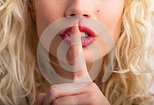 Woman showing shh sign photo