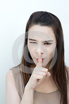 Woman showing silent hand sign