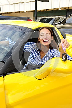 Woman showing sitting inside of her new sports car