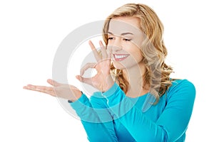 Woman showing something or copyspase