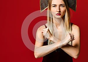 Woman showing a stop arms crossed. On a red background.