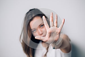 Woman showing stop gesture, on a white background