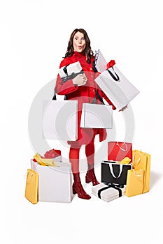 Woman showing surprised emotion with bags and presents