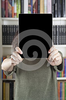 Woman showing tablet at library