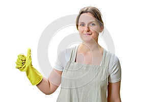 Woman showing thumb up approving gesture while cleaning home kitc