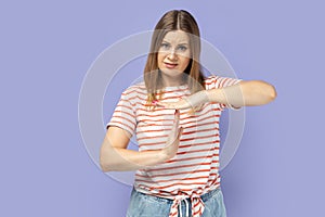 Woman showing time out gesture, looking with imploring eyes, hurry to meet deadline.