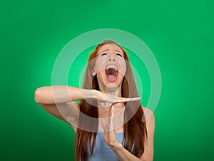 Woman showing time out hand gesture, frustrated screaming
