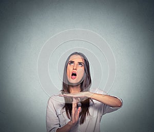 Woman showing time out hand gesture, frustrated screaming to stop