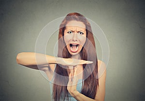 Woman showing time out hand gesture, frustrated screaming