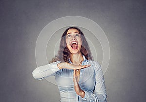 Woman showing time out hand gesture, screaming to stop it