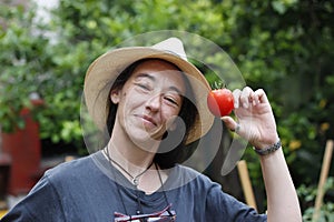 Woman showing a tomato
