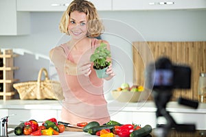 woman showing vegetables to camera