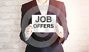 Woman showing white card with JOB OFFERS word . Business