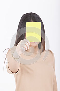 Woman showing yellow card