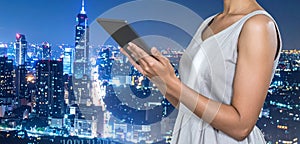 Multiple exposure of female programmer with tablet, digital binary code and night city.