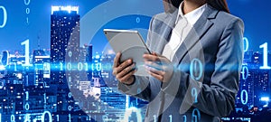 Multiple exposure of female programmer with tablet, digital binary code and night city.